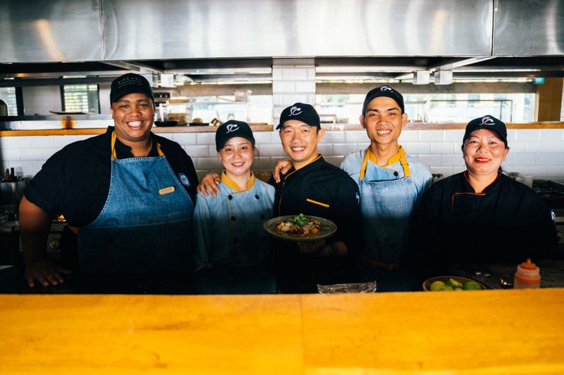 Wing Snob team members collaborating in a modern restaurant environment